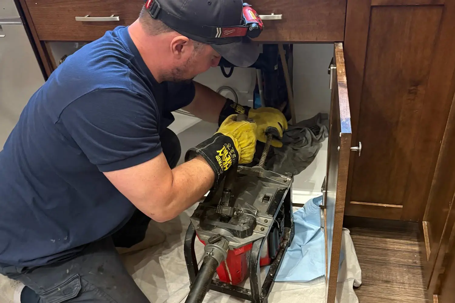 Reece from Harper's Plumbing in Calgary using a drain snake