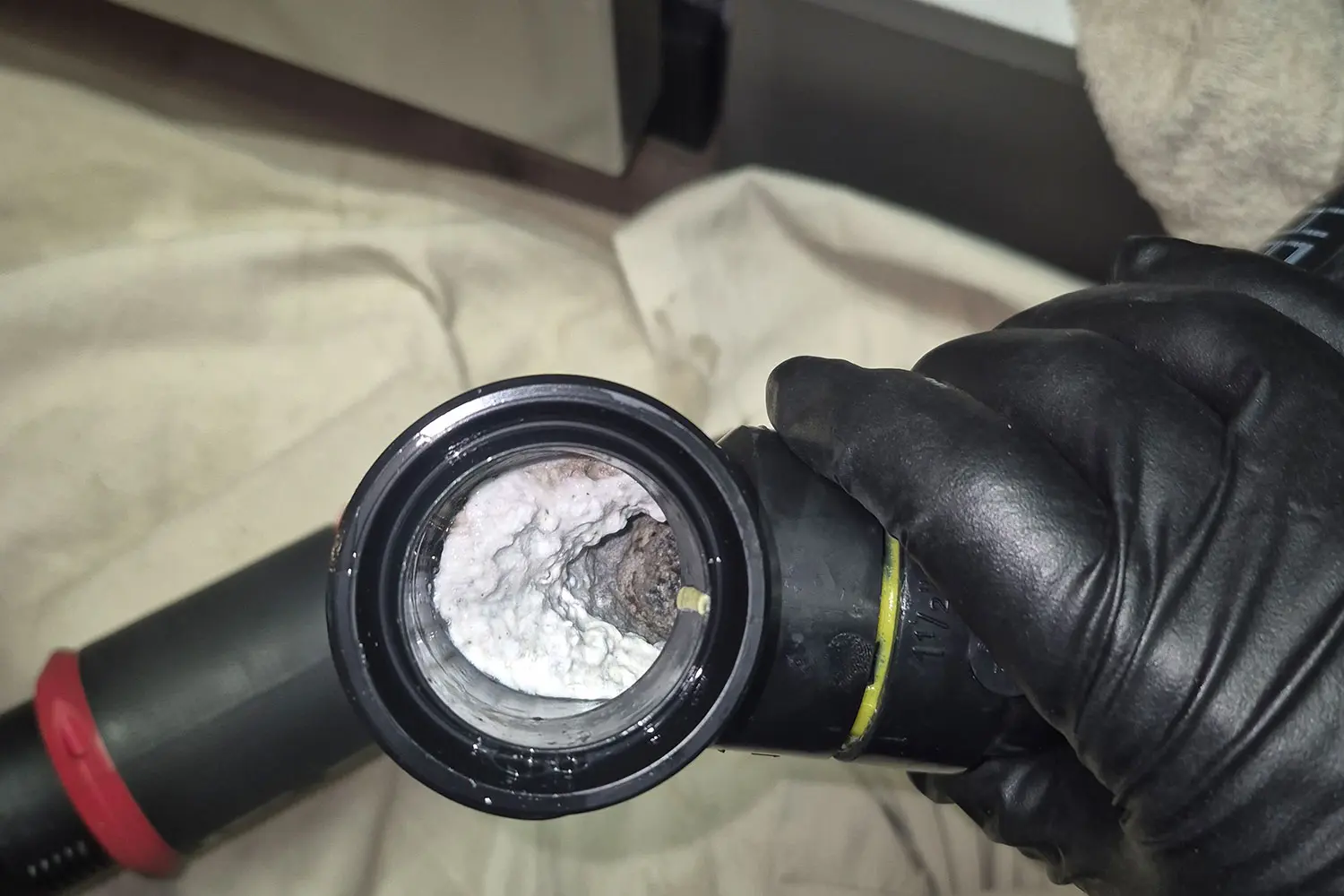 a kitchen drain pipe from a Calgary home that has a white build up inside causing it to drain slowly
