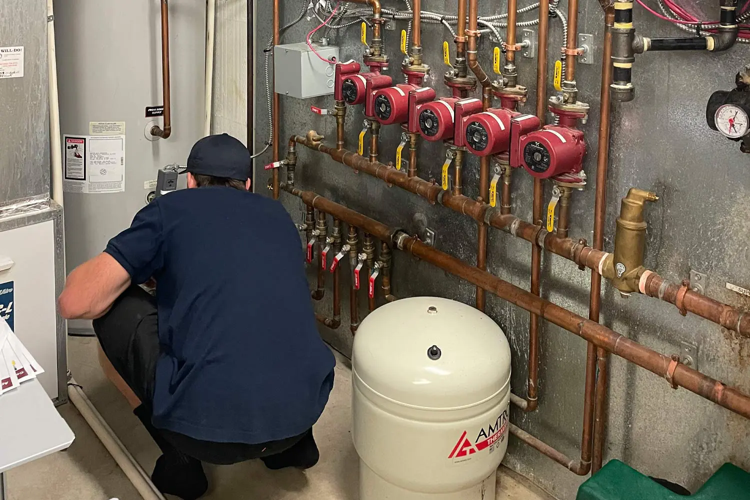 Calgary plumber performing a plumbing inspection on water heater and boiler system