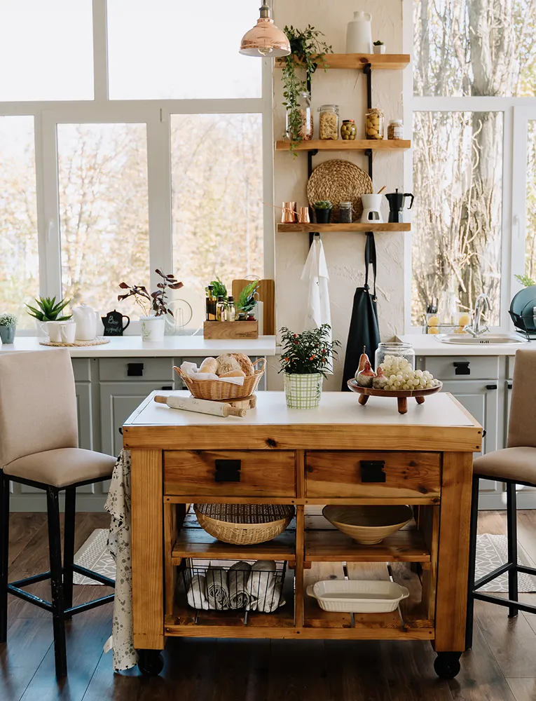 Bright, rustic kitchen with wood island, open shelving, and natural light—showcasing modern farmhouse design and plumbing fixtures