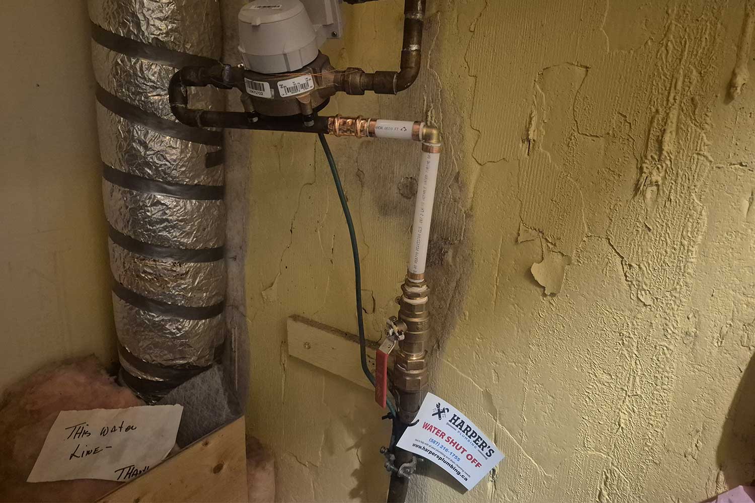 water shut off valve in Calgary home with Harper's Plumbing tag